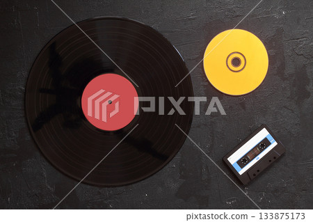 Vinyl record, cd, audio and video cassettes top view Vinyl record, cd, audio and video cassettes top view 133875173