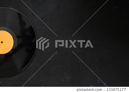 Aged black paper cover and vinyl LP record isolated on black background 133875177