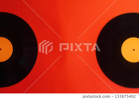 Vinyl record on a red background. Retro style. Top view. 133875402