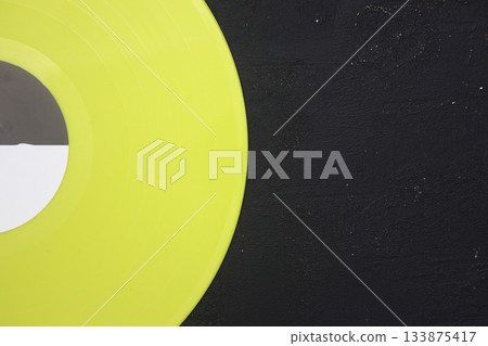 Aged black paper cover and vinyl LP record isolated on black background Aged black paper cover and vinyl LP record isolated on black background 133875417