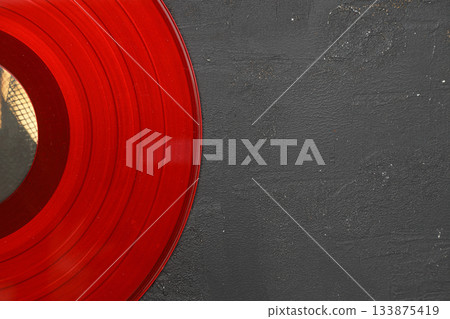Aged black paper cover and vinyl LP record isolated on black background Aged black paper cover and vinyl LP record isolated on black background 133875419
