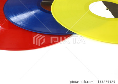 colorful Vinyl record on a white background. Retro style. Top view. Flat lay, copy space. colorful Vinyl record on a white background. Retro style. Top view. Flat lay, copy space. 133875425