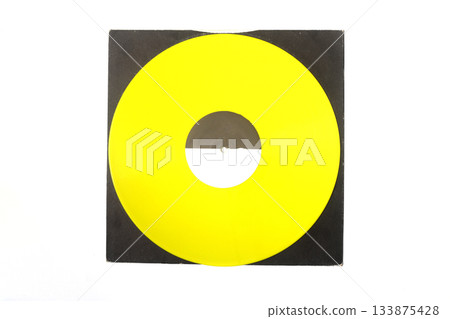 Aged black paper cover and yellow vinyl LP record isolated on white background 133875428