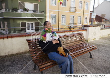 Peaceful moment of woman drinking coffee with pastel backdrop 133875540