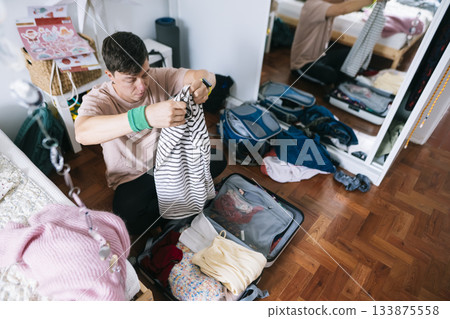 Asian learner carefully packs for overseas semester trip 133875558