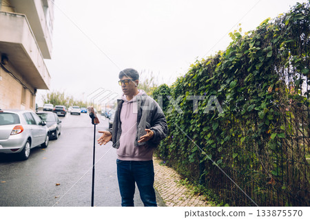 Everyday moment captured with man in relaxed clothing outdoors Everyday moment captured with man in relaxed clothing outdoors 133875570