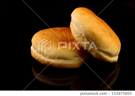 Yellow burger bread isolated on black background Yellow burger bread isolated on black background 133875605