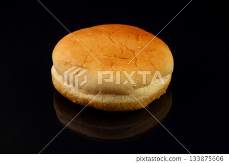 Yellow burger bread isolated on black background Yellow burger bread isolated on black background 133875606