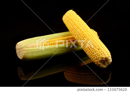 fresh yellow sweet corn on black color background, copy space fresh yellow sweet corn on black color background, copy space 133875620
