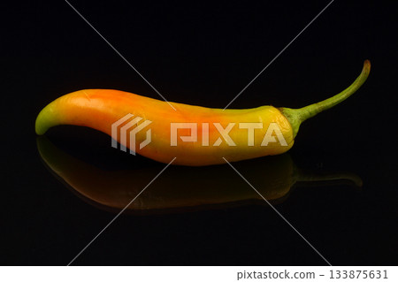 red hot chili pepper on black background. red hot chili pepper on black background. 133875631