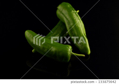 Green chili peppers on black background. Close up 133875642