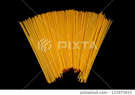 Spaghetti isolated on black background. Long italian pasta on white. Spaghetti isolated on black background. Long italian pasta on white. 133875655