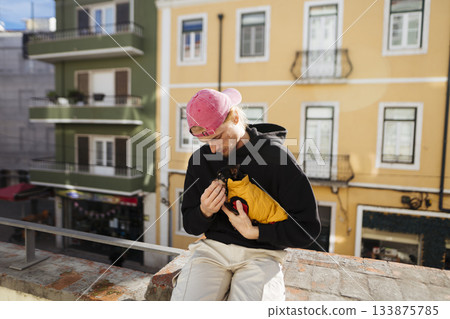 Tender shot of individual and puppy enjoying sunny rooftop companionship Tender shot of individual and puppy enjoying sunny rooftop companionship 133875785