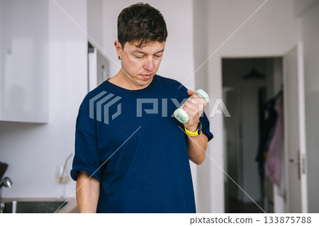 Person carefully checks dosage details on pill bottle label 133875788