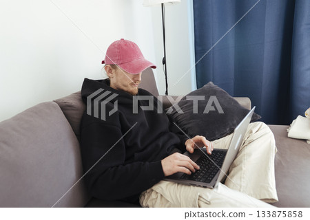 Casual coder at home, Relaxed developer working comfortably indoors Casual coder at home, Relaxed developer working comfortably indoors 133875858
