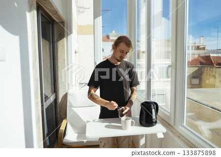 Serene morning setting featuring coffee and cityscape view at dawn Serene morning setting featuring coffee and cityscape view at dawn 133875898