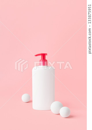 Bottle of intimate hygiene gel on pastel pink background. Beauty treatment concept. Bottle of intimate hygiene gel on pastel pink background. Beauty treatment concept. 133875951