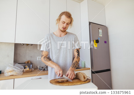 Individual preparing meal with rustic tools and modern decor 133875961