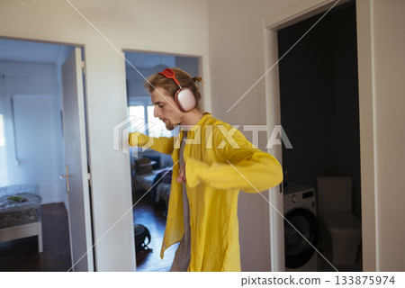 Male instructor performing energetic dance in living room setting 133875974
