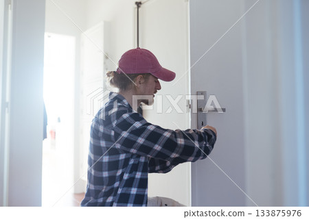 Bright corridor showcasing skilled security system technician at work 133875976