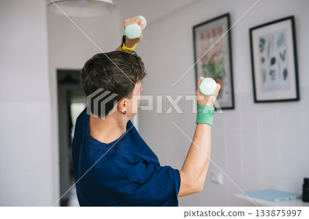 Slow motion lifting exercise for shoulder recovery in peaceful space 133875997