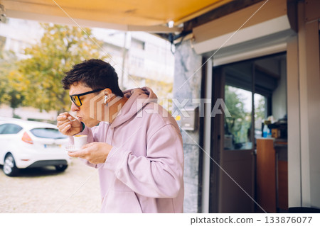 Man indulging in warm soup outdoors during cozy autumn day 133876077
