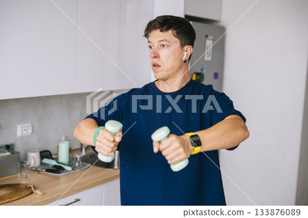 Genuine fitness session taking place in apartment kitchen 133876089