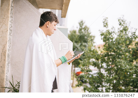 Man on balcony developing entrepreneurial ideas with notes and sketches Man on balcony developing entrepreneurial ideas with notes and sketches 133876247