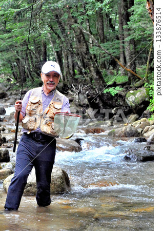 A fisherman fishing in the Arakawa River that flows beside the Otome Mine A fisherman fishing in the Arakawa River that flows beside the Otome Mine 133876514