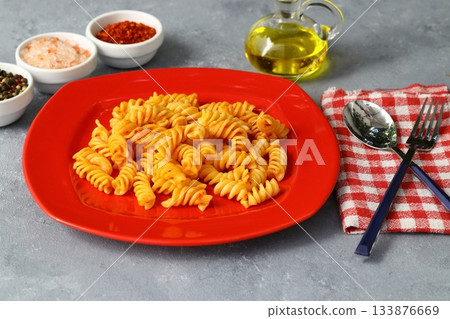 Fusilli pasta in tomato sauce. gray background. Italian food concept Fusilli pasta in tomato sauce. gray background. Italian food concept 133876669