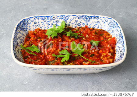 A spicy Turkish appetizer acili ezme made with tomatoes, pepper, parsley, mint, olive oil A spicy Turkish appetizer acili ezme made with tomatoes, pepper, parsley, mint, olive oil 133876767