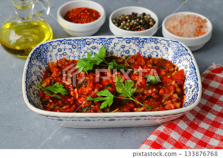 A spicy Turkish appetizer "Acili ezme" made with tomatoes, pepper, parsley, mint, olive oil A spicy Turkish appetizer "Acili ezme" made with tomatoes, pepper, parsley, mint, olive oil 133876768