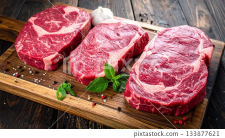 Different types of raw A5 beef on the wooden background Different types of raw A5 beef on the wooden background 133877621