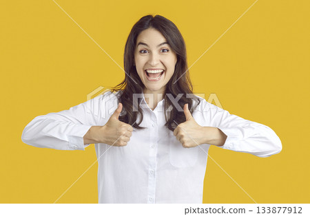 Joyful excited Caucasian woman shown sign of approval gesturing with two thumbs up. Joyful excited Caucasian woman shown sign of approval gesturing with two thumbs up. 133877912