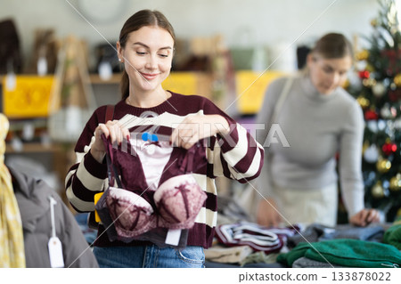 Woman on sale in boutique choosing a set of bras 133878022