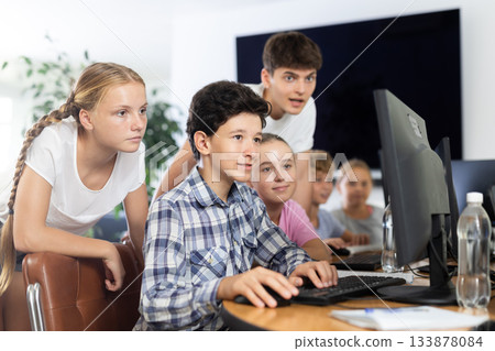 Classmates solve computer problem together in school computer class Classmates solve computer problem together in school computer class 133878084