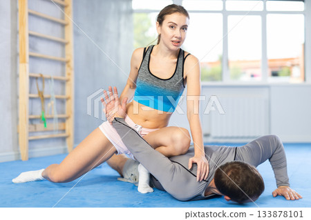 Adult man and young woman training self-defense techniques 133878101
