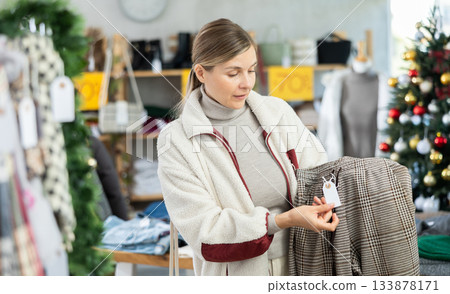 Adult woman choosing trousers in clothing store Adult woman choosing trousers in clothing store 133878171