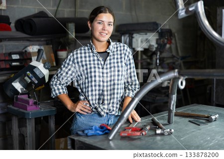 Portrait of young female worker at metallurgical plant with caliper in her hands Portrait of young female worker at metallurgical plant with caliper in her hands 133878200