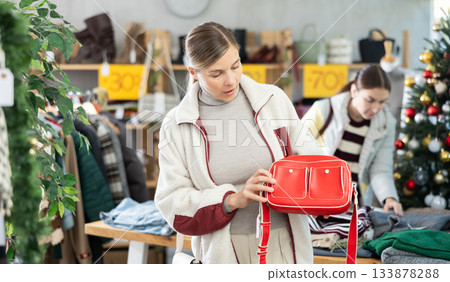 Adult woman choosing handbag in clothing store 133878288
