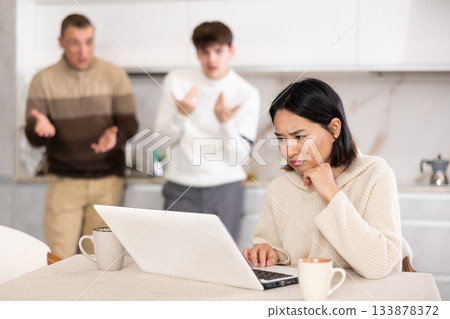 Guy and man quarrel with young woman with laptop Guy and man quarrel with young woman with laptop 133878372