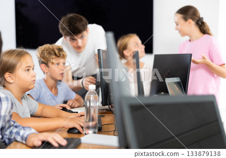 Portrait of female schoolgirl at computers in computer class Portrait of female schoolgirl at computers in computer class 133879138