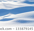 Simple background material of a snowy field covered in snow 133879145