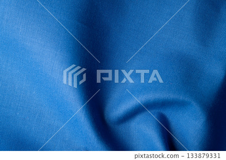 Wrinkled and textured blue fabric texture background 133879331