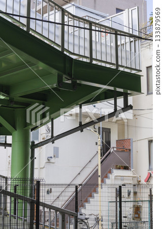 Pedestrian bridge structure and residential area scenery 133879569