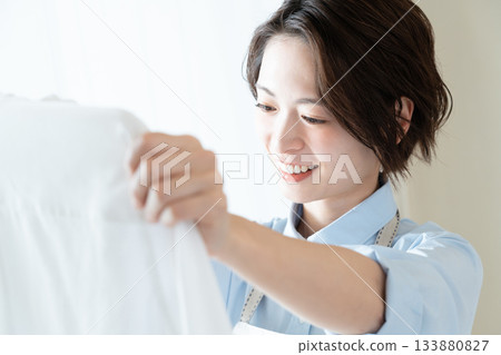 Young lady hanging laundry Young lady hanging laundry 133880827