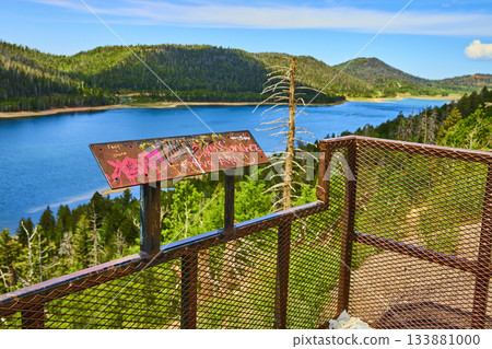 Observation Deck Overlooking Blue Lake and Forested Hills in Summer 133881000