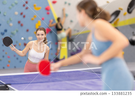Two women play table tennis with passion 133881235
