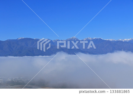 Northern Alps in early winter floating in a sea of clouds 133881865
