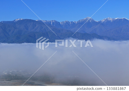 Northern Alps in early winter floating in a sea of clouds 133881867